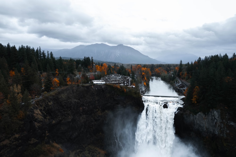 a view of a waterfall in the middle of a forest