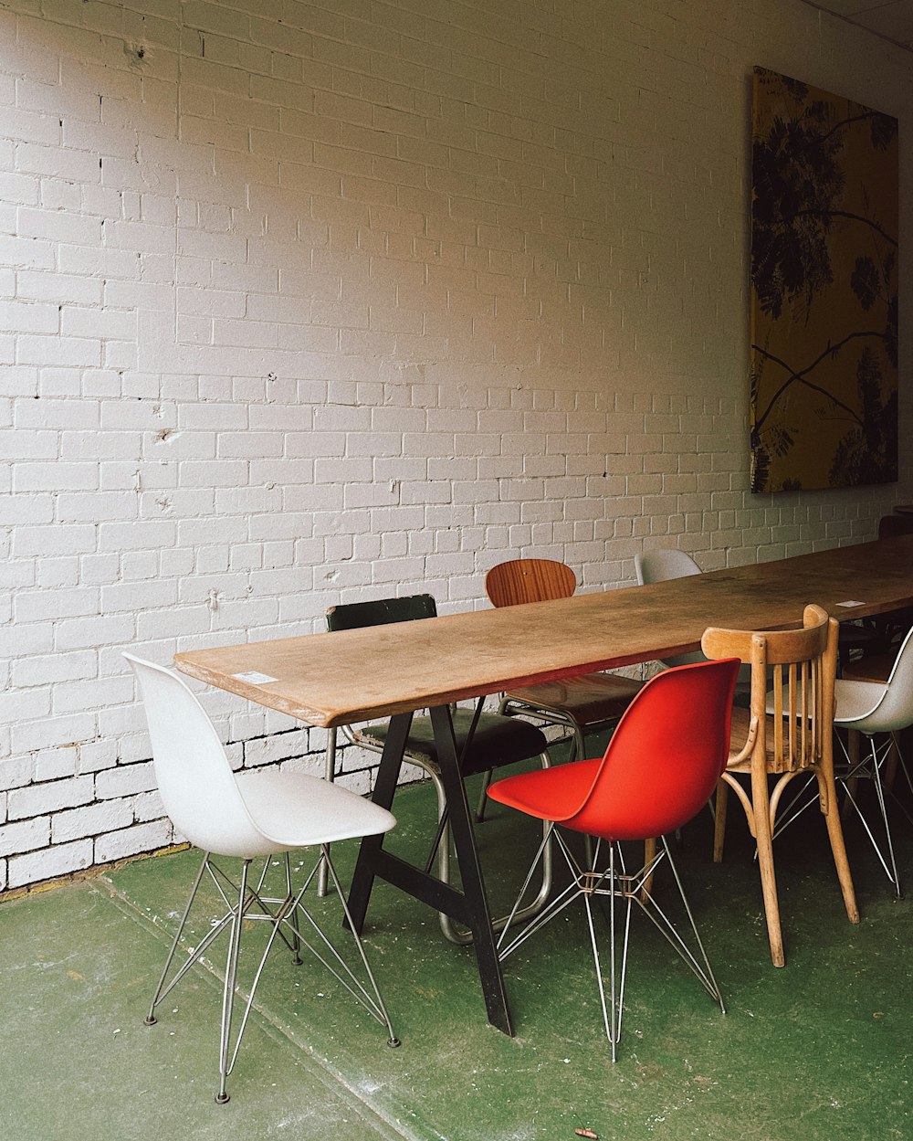 a long table with chairs around it in a room