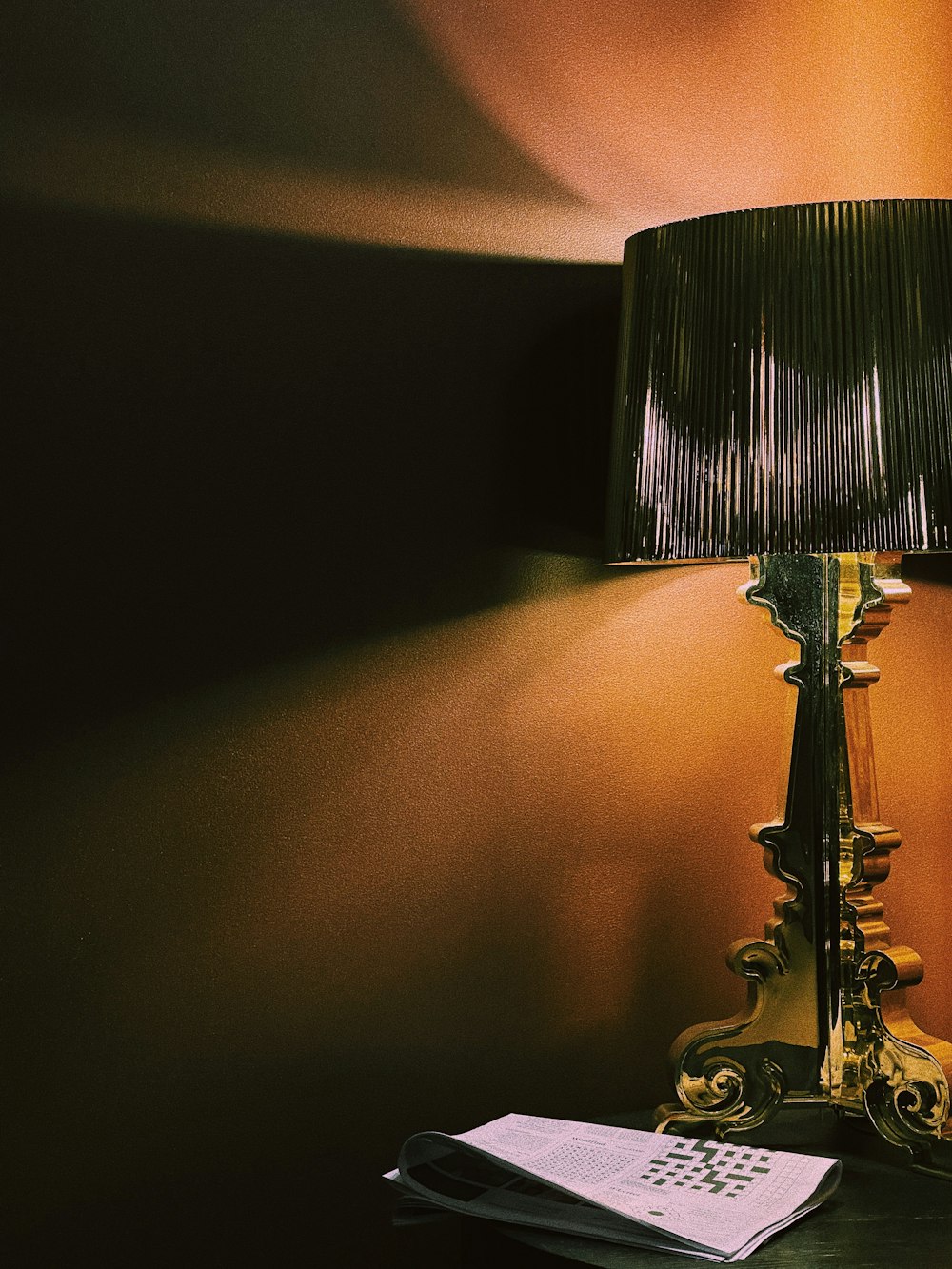 a lamp sitting on top of a table next to a book