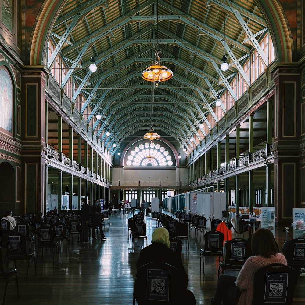 a group of people sitting in chairs in a building