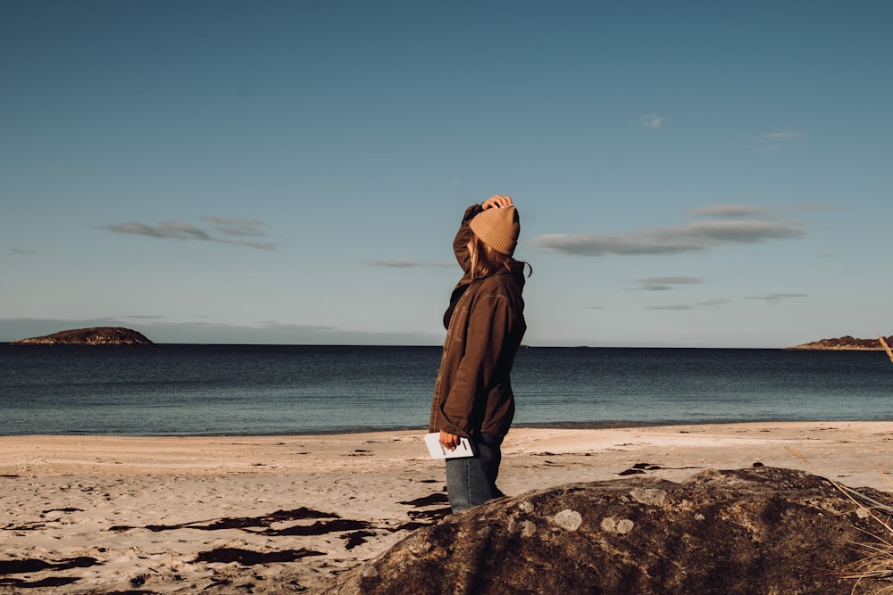 a person standing on a beach near the ocean