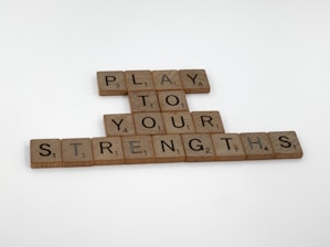 scrabble tiles spelling play to your strength