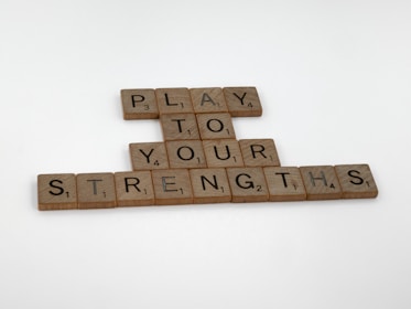scrabble tiles spelling play to your strength