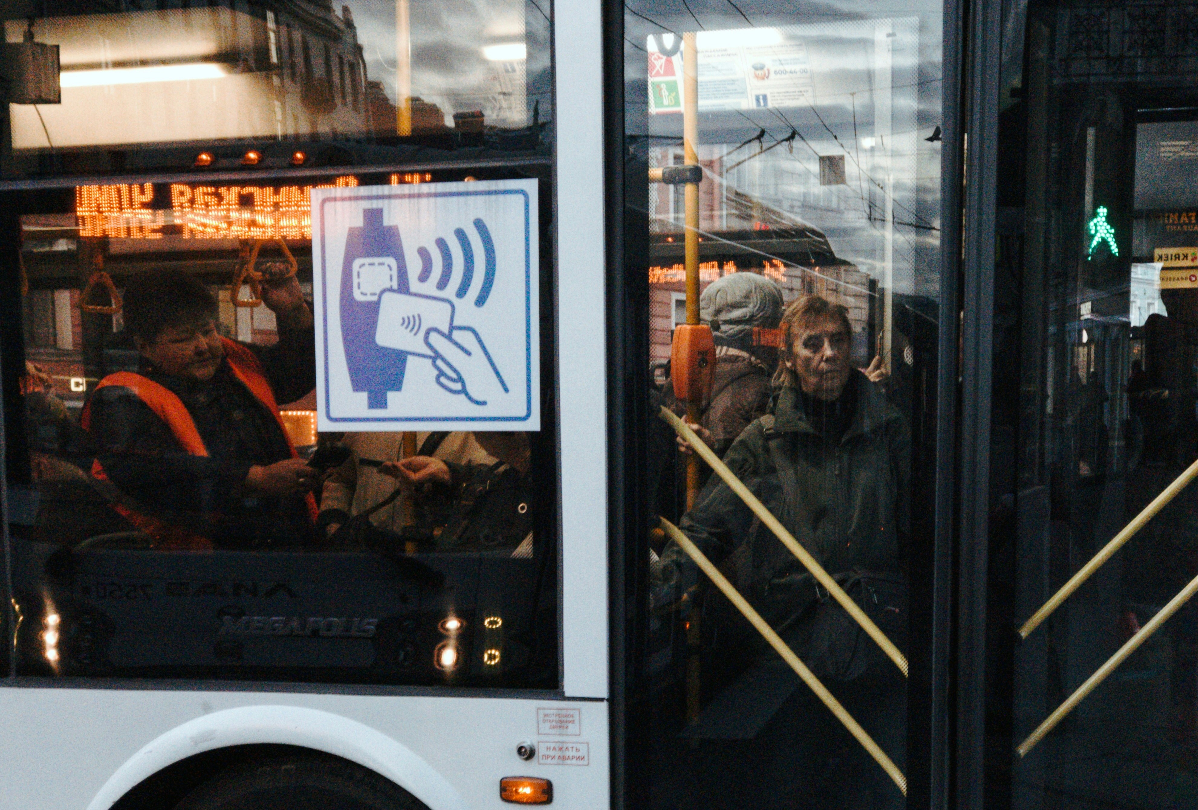 a group of people standing next to a bus