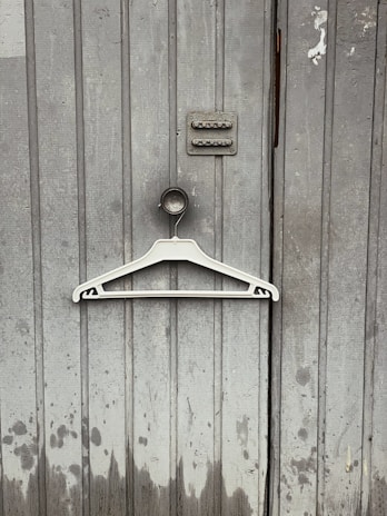 A sturdy multi-functional hanger supporting a heavy winter coat without bending.