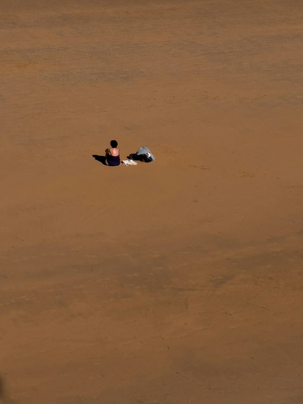 a person laying on the ground in the middle of a field