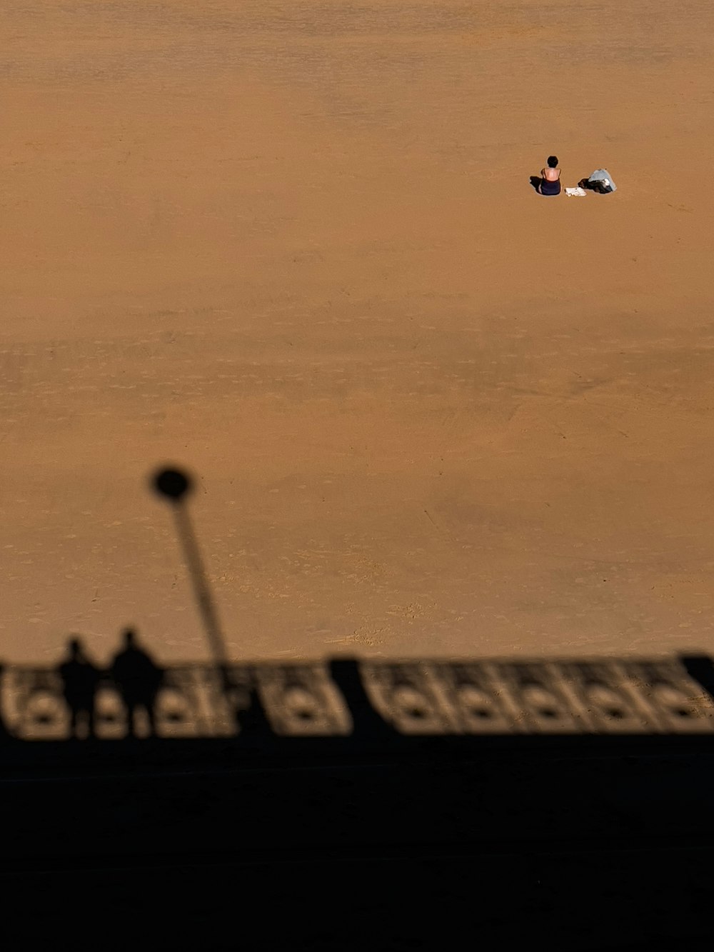 a person laying on the ground with a kite in the air