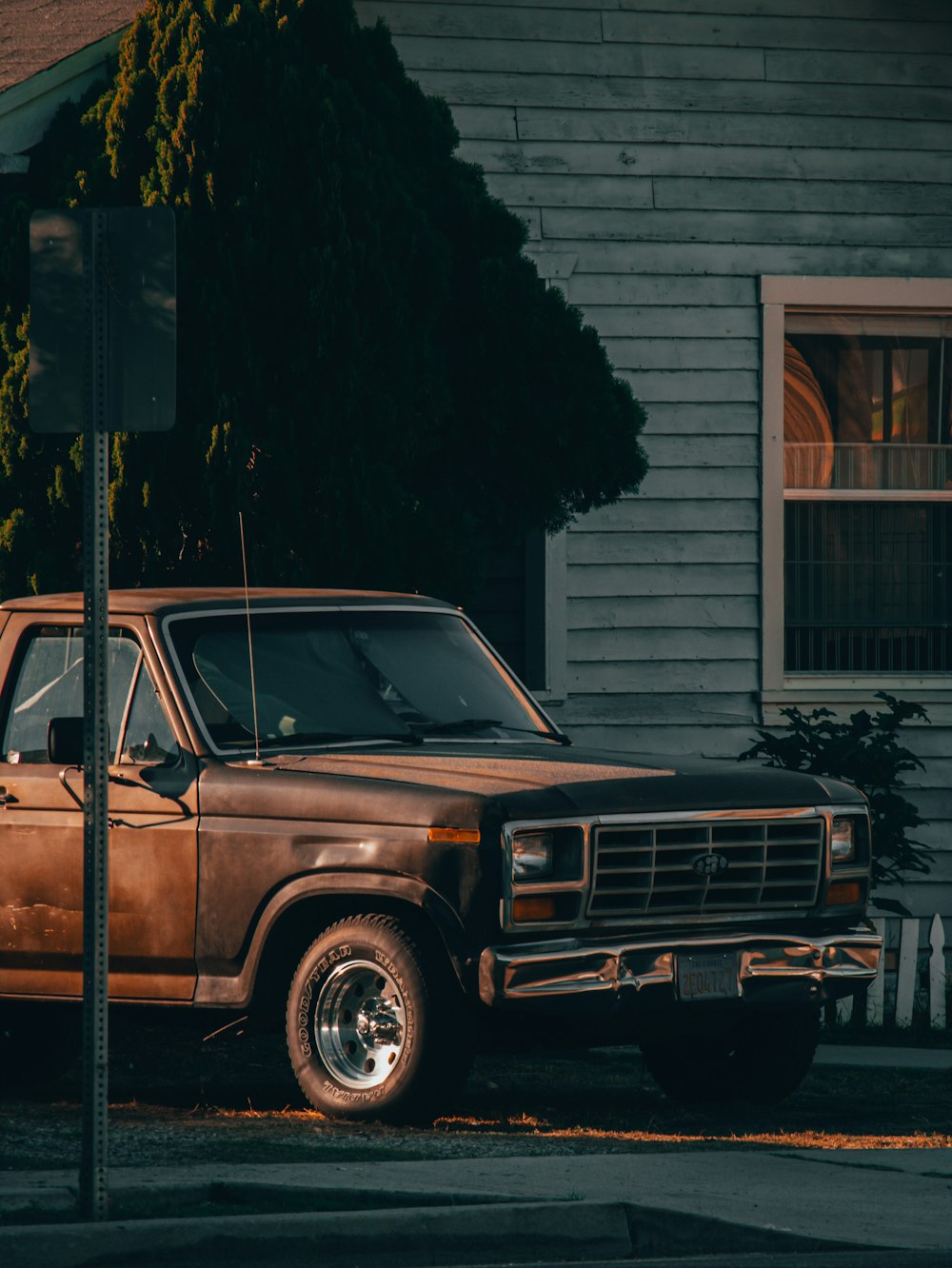 a brown truck parked on the side of a road