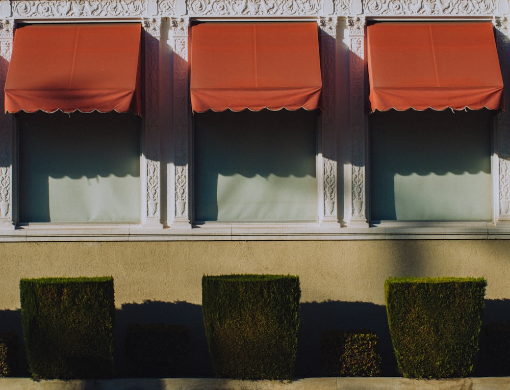 a row of red awnings on the side of a building
