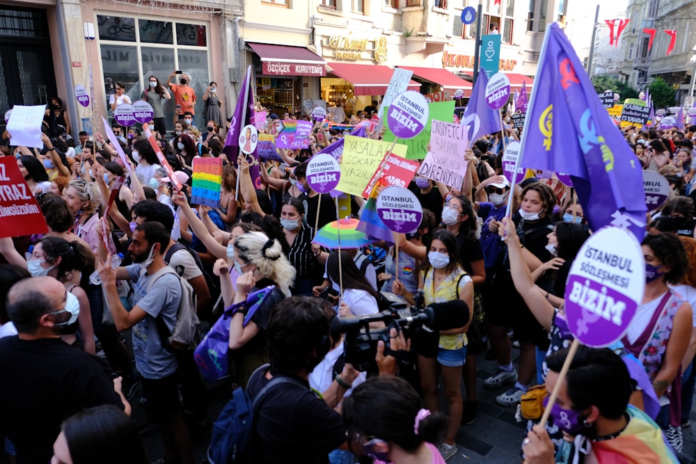 a large group of people holding signs and flags