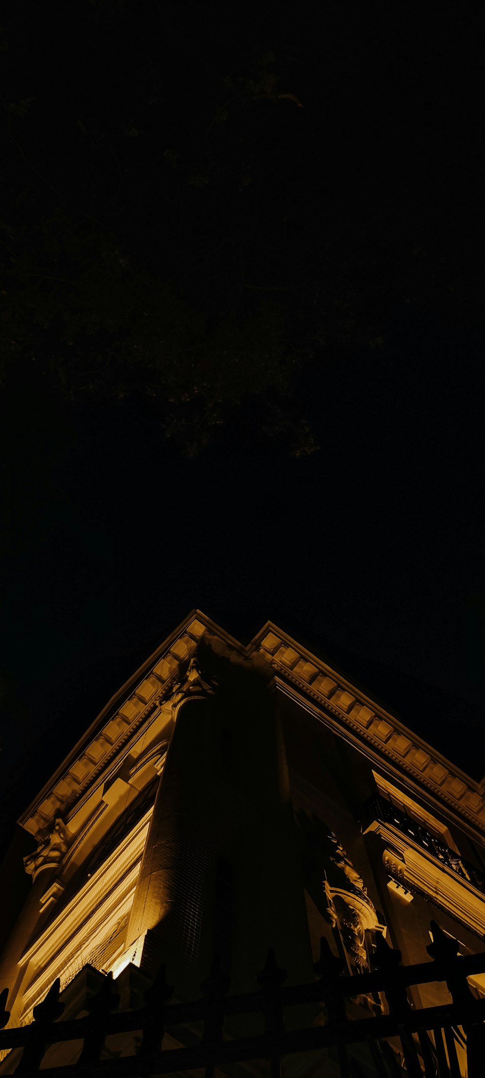 a clock tower lit up at night with a sky background