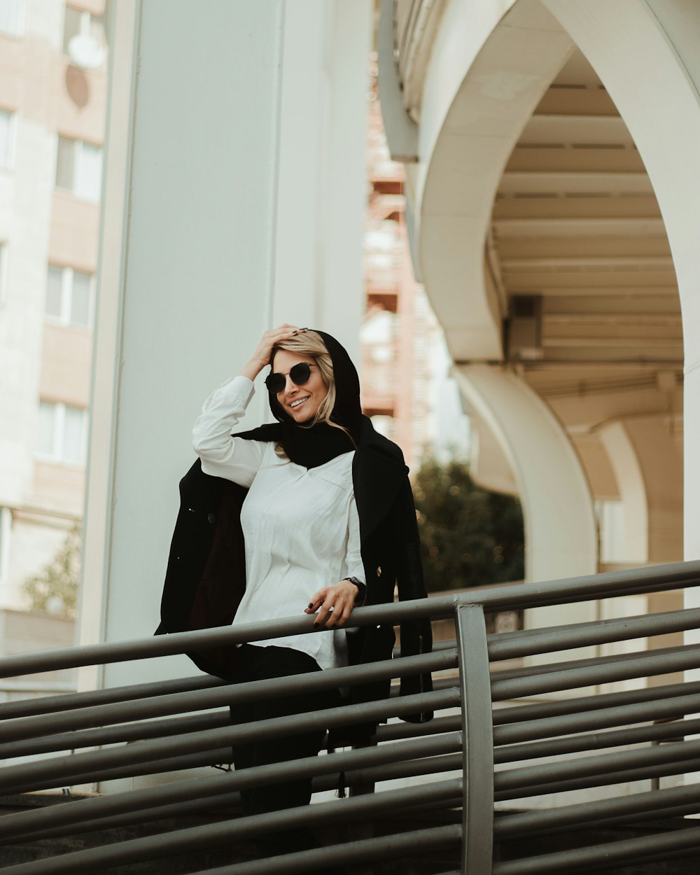 a woman in a black and white outfit and sunglasses