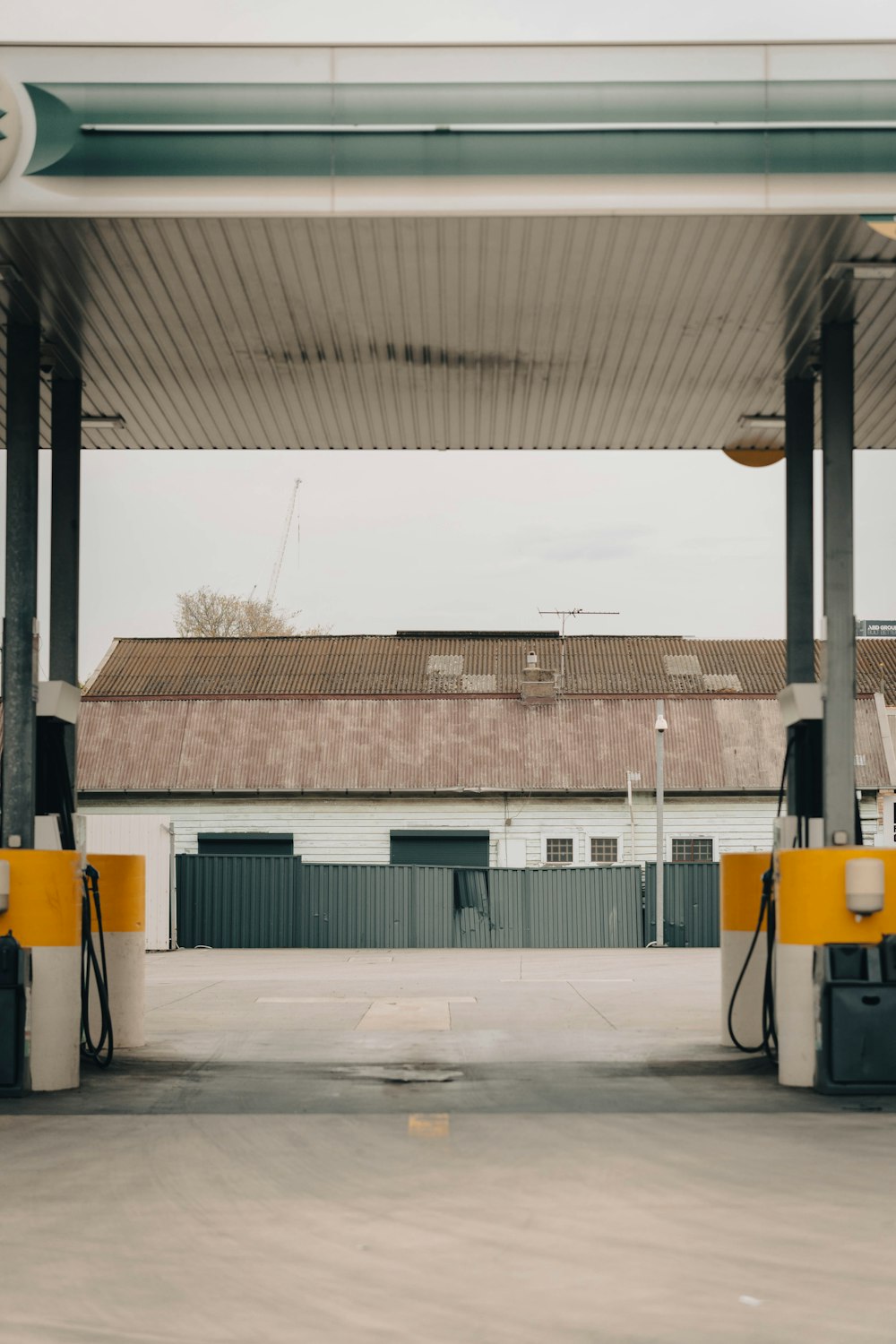 a gas station with yellow and white gas pumps