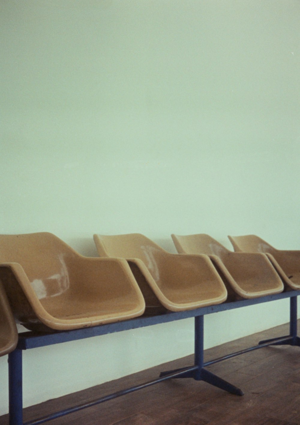 a row of chairs sitting on top of a wooden floor