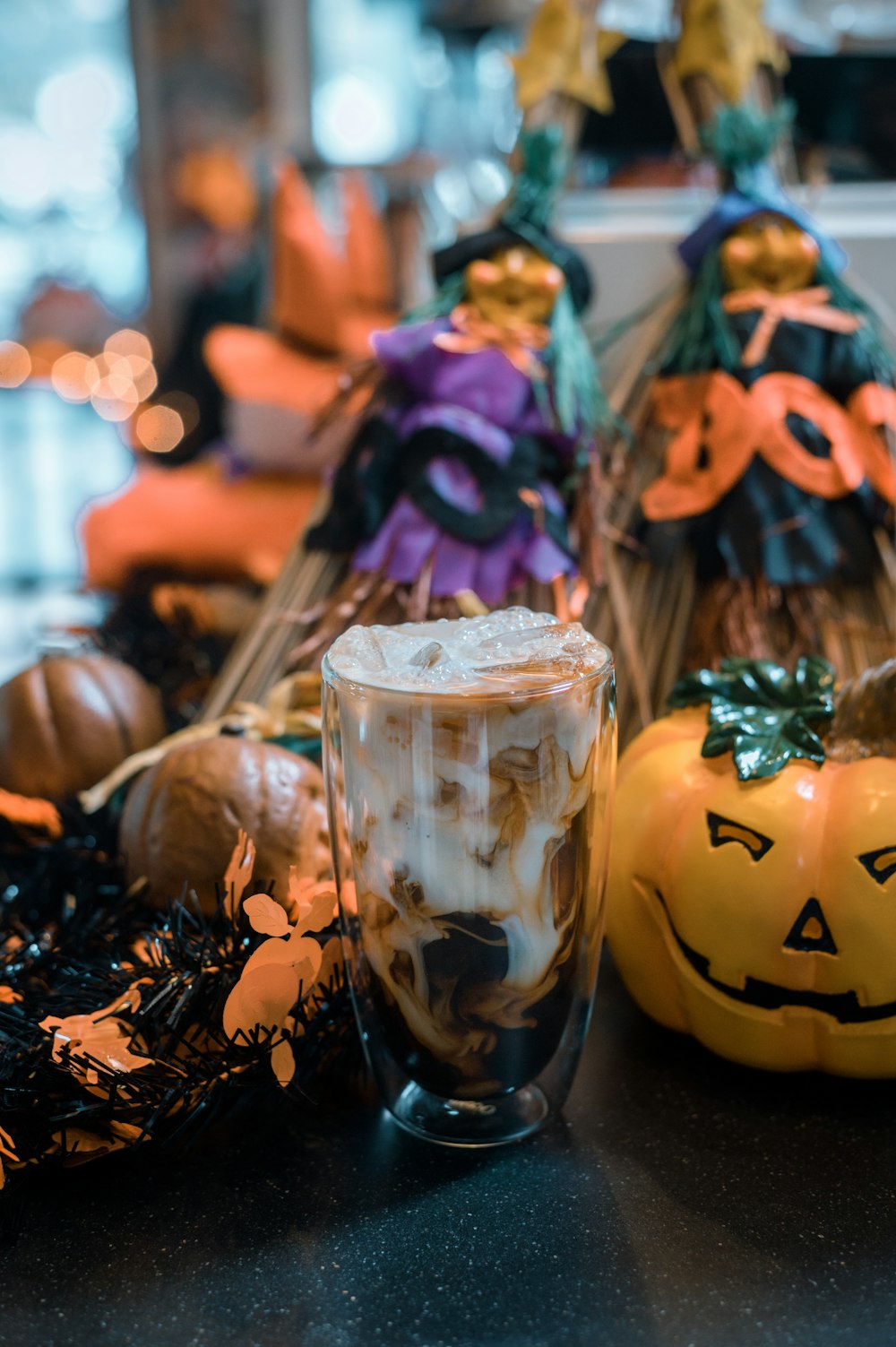 a table topped with two pumpkins and a cup of coffee