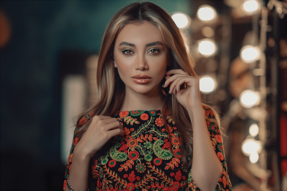 a woman is posing in front of a mirror