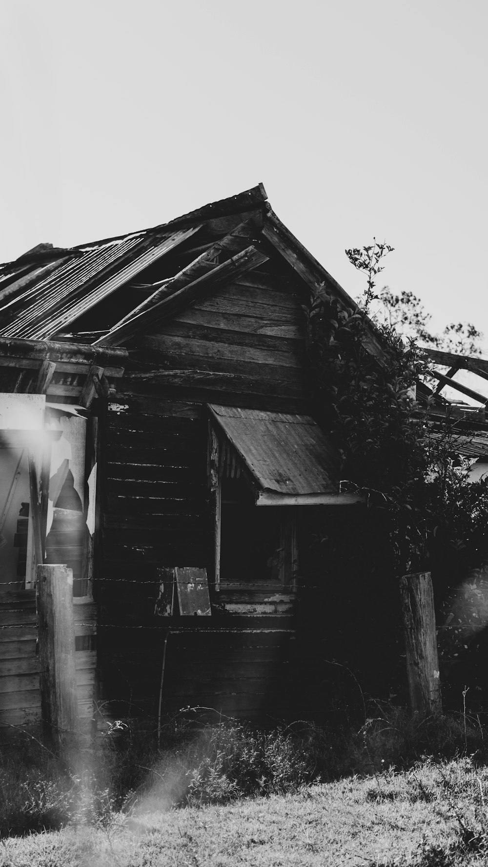 a black and white photo of an old house