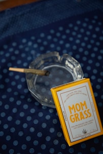 a cigarette sitting on top of a glass ashtray