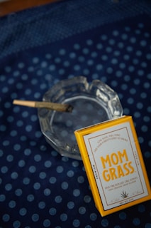a cigarette sitting on top of a glass ashtray