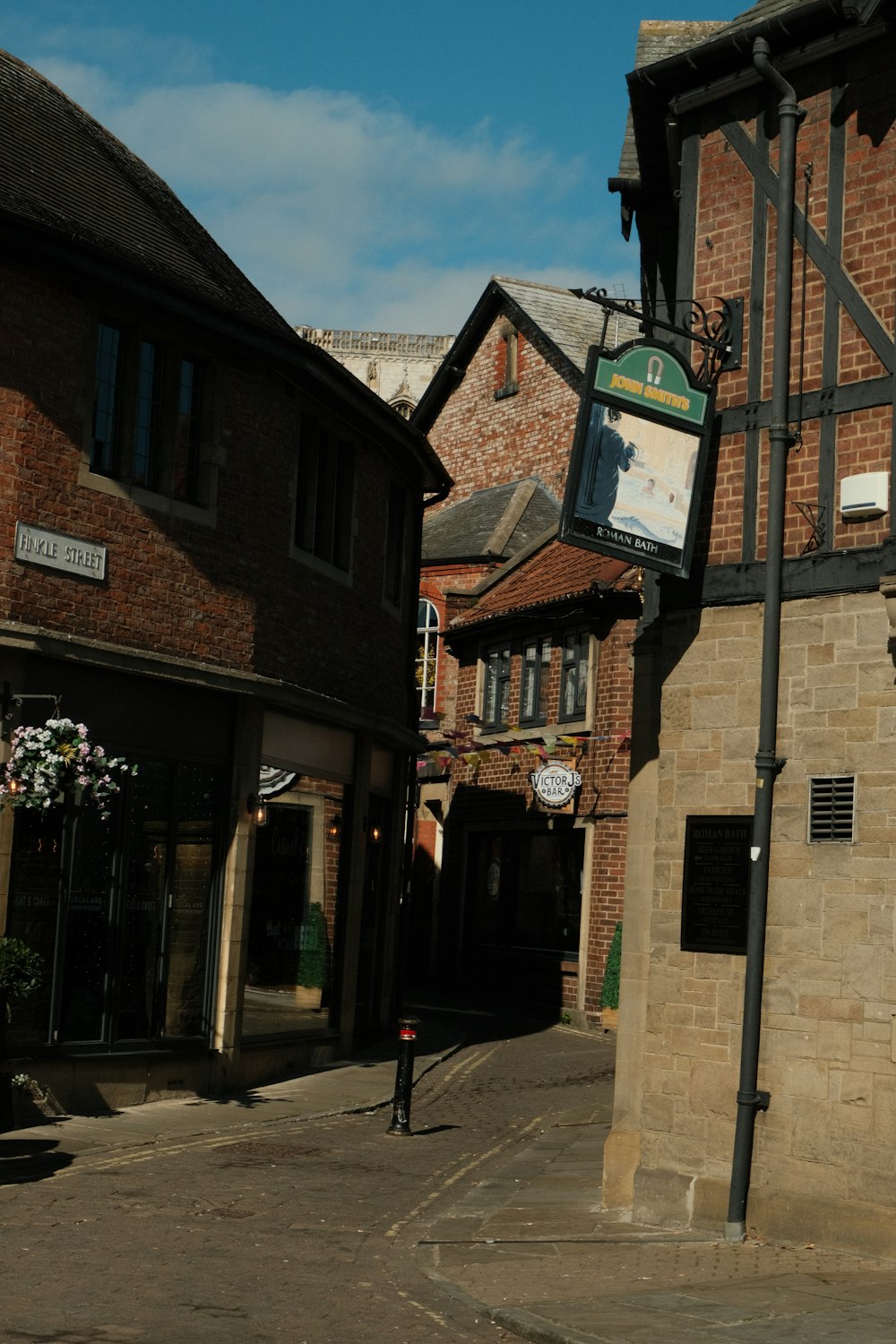 a street corner with a clock on the side of a building