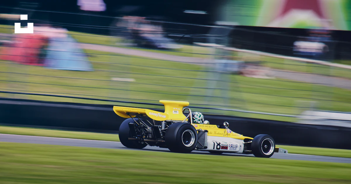 Yellow Turn Racing A yellow race car driving down a race track photo – Free Donington park ...