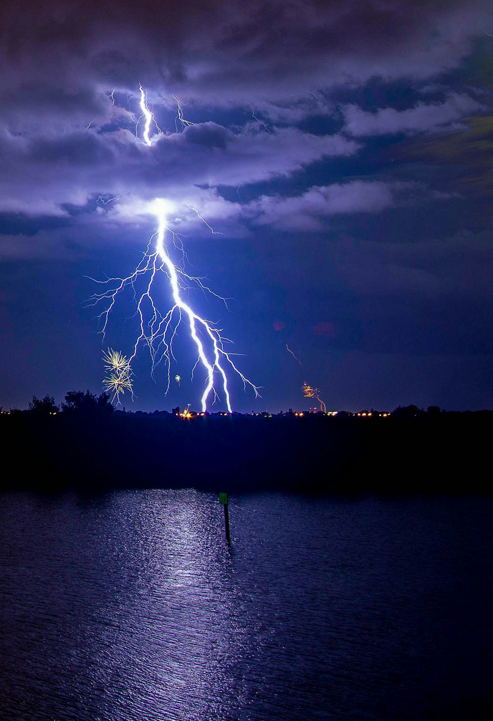 a lightning bolt is seen over a body of water