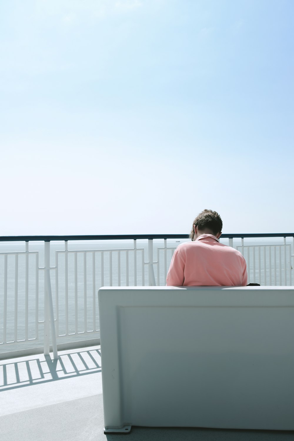 a person sitting in a bath tub on a balcony