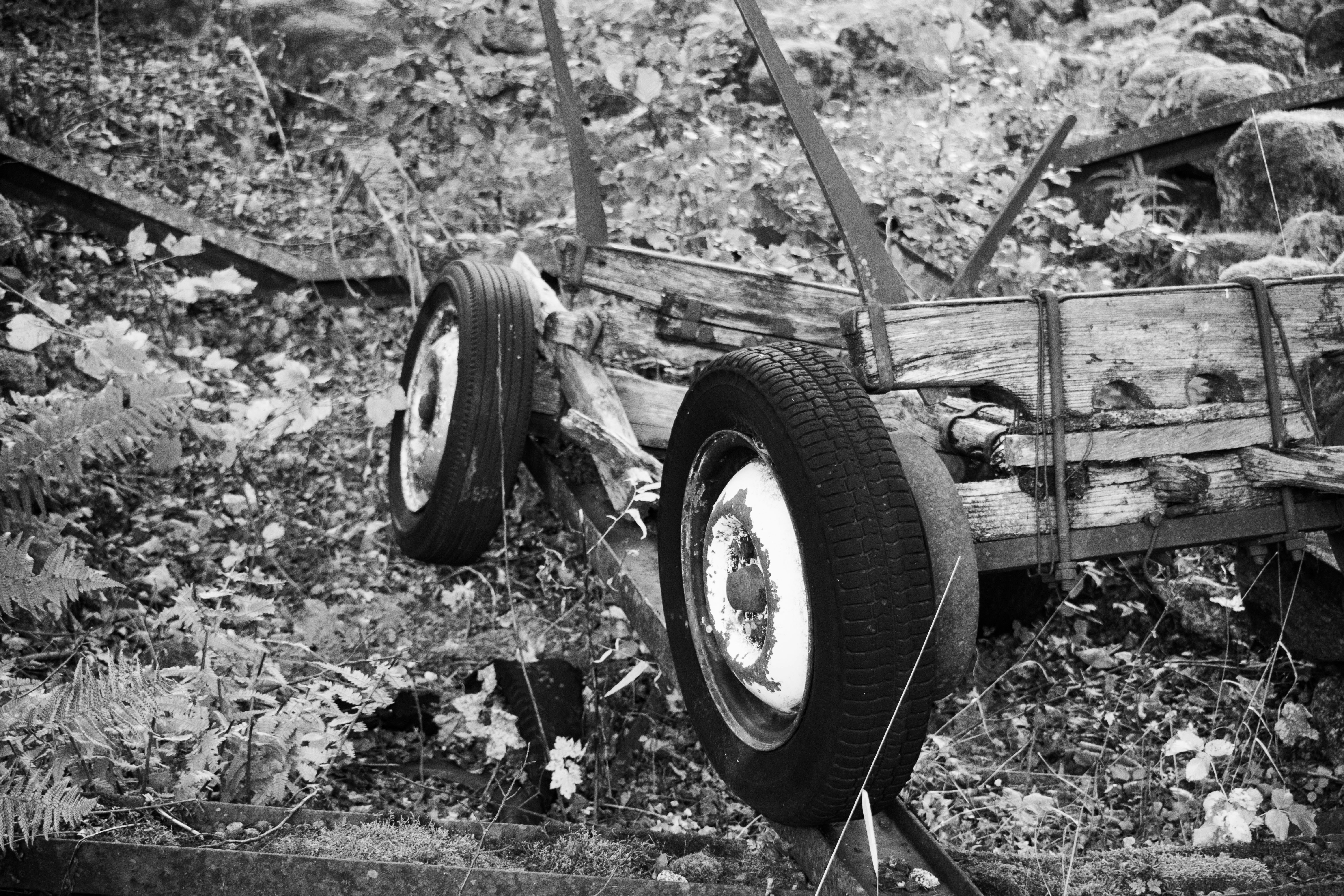 a black and white photo of a broken down truck