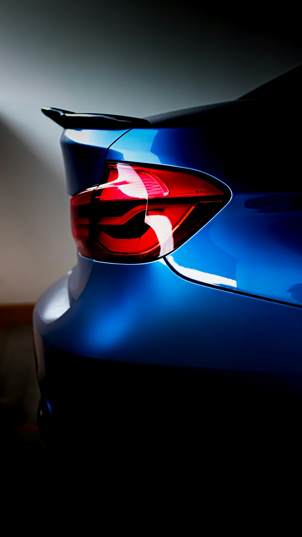 a close up of the tail lights of a blue car