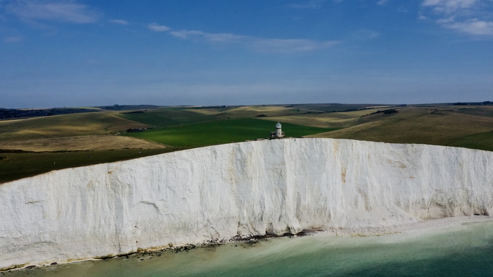 a person standing on top of a white cliff