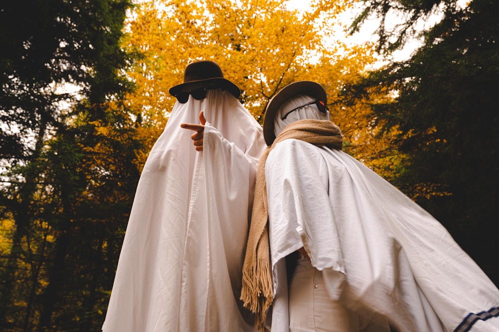 two people dressed up in costumes in the woods