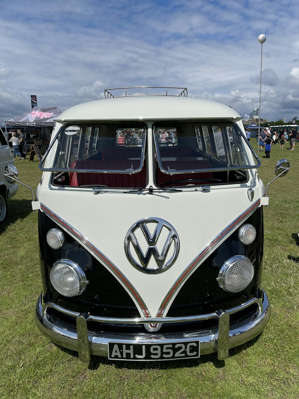 a vw bus is parked in the grass