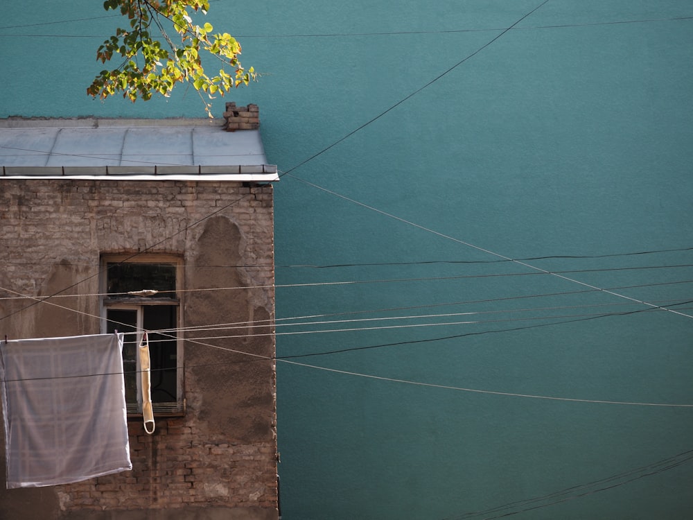 clothes hanging on a clothes line next to a building