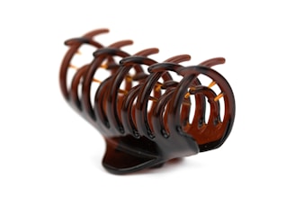 a close up of a wooden object on a white background