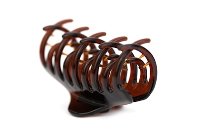 a close up of a wooden object on a white background