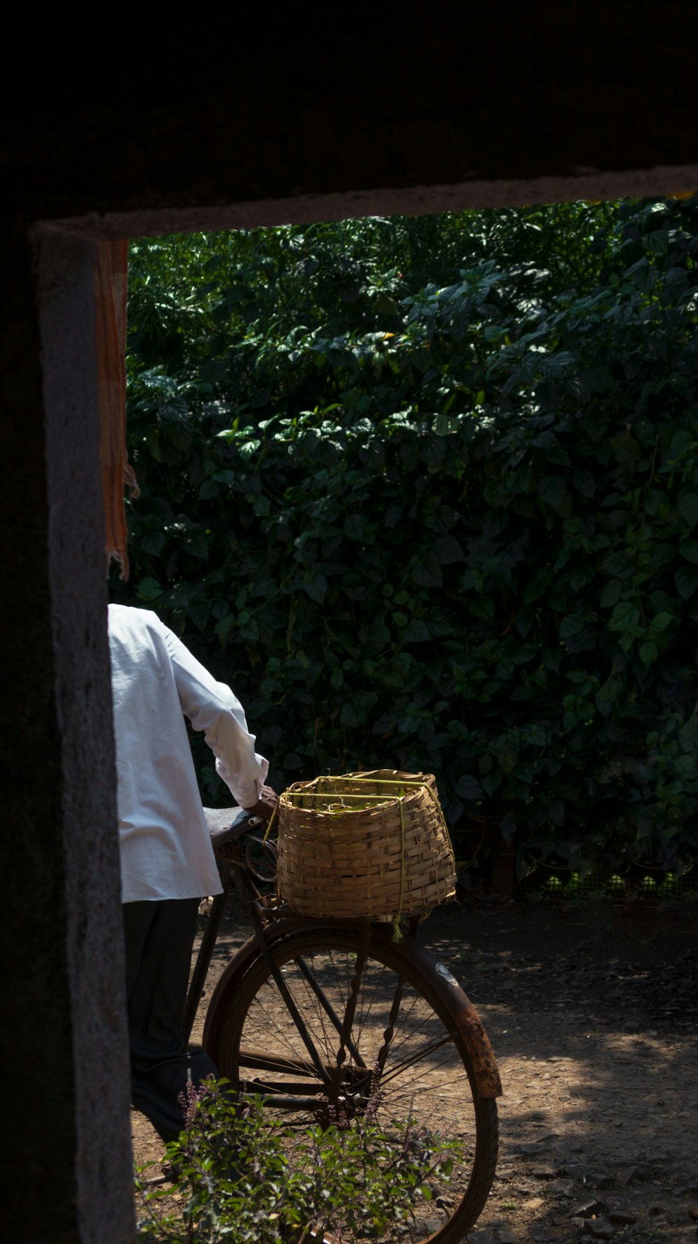 a man standing next to a bike with a basket on it