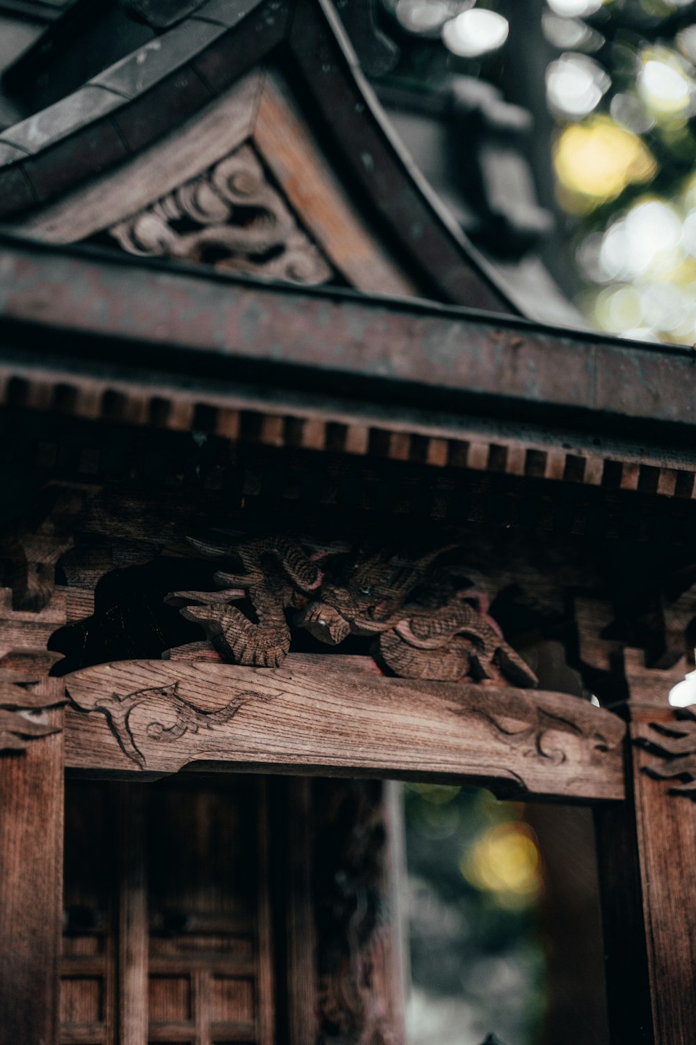 a close up of a wooden structure with carvings on it