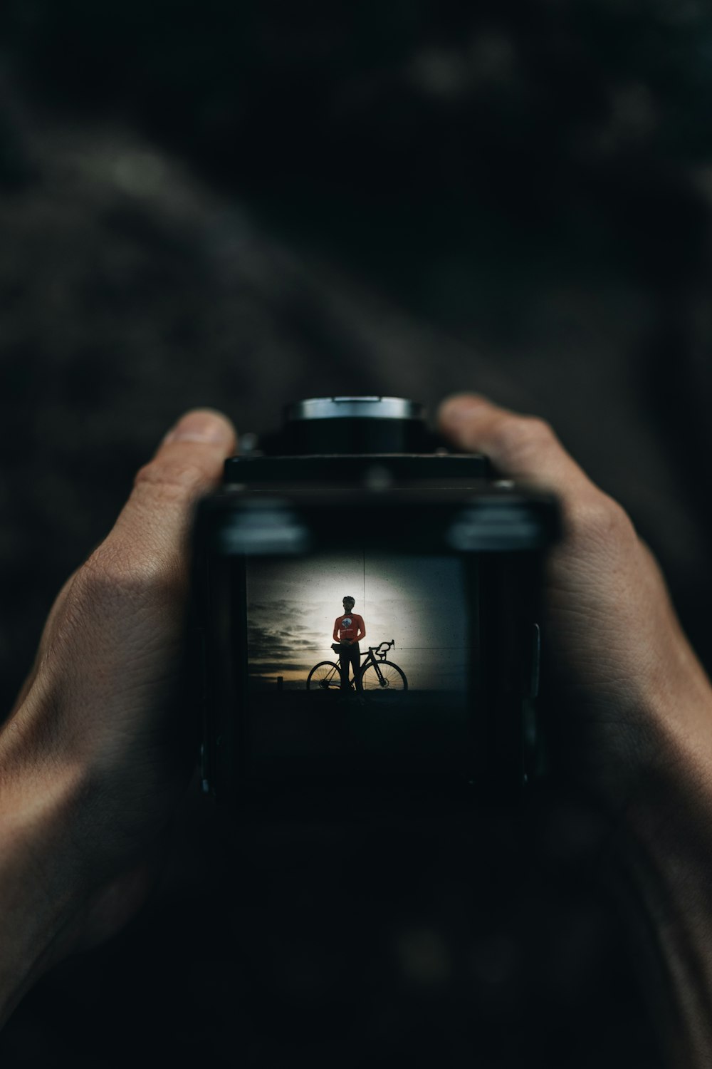 a person holding a camera up to take a picture