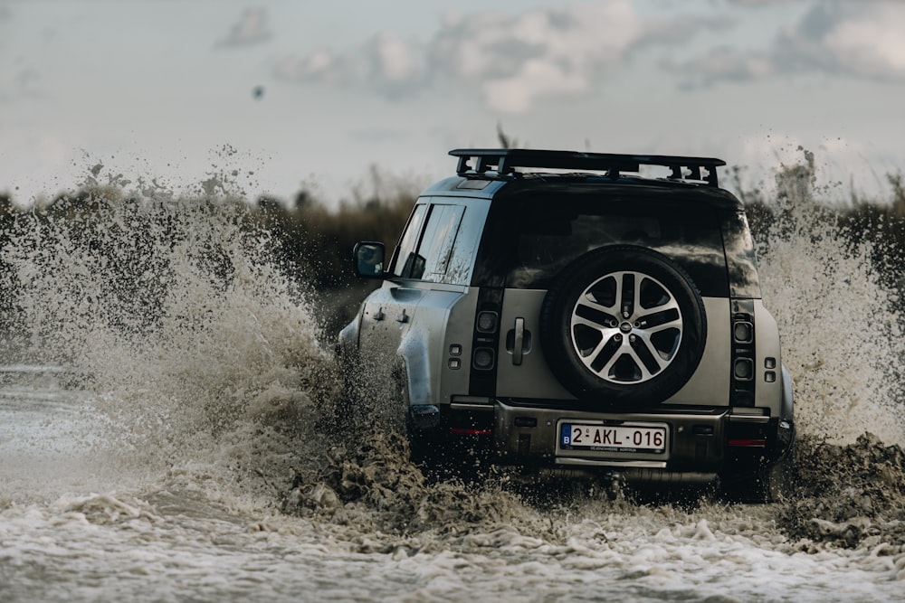 a jeep driving through a body of water