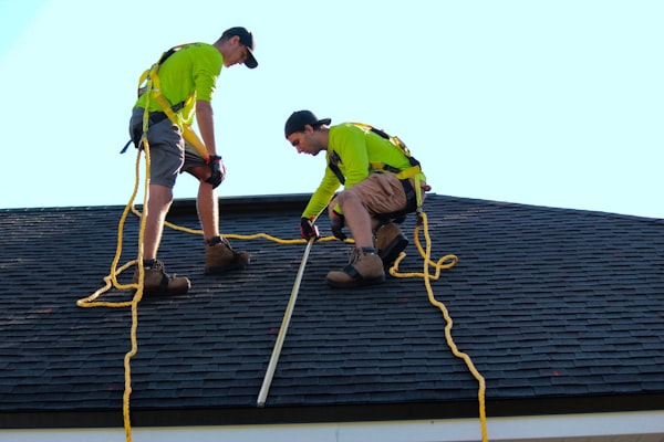 Roofers working on shingles
