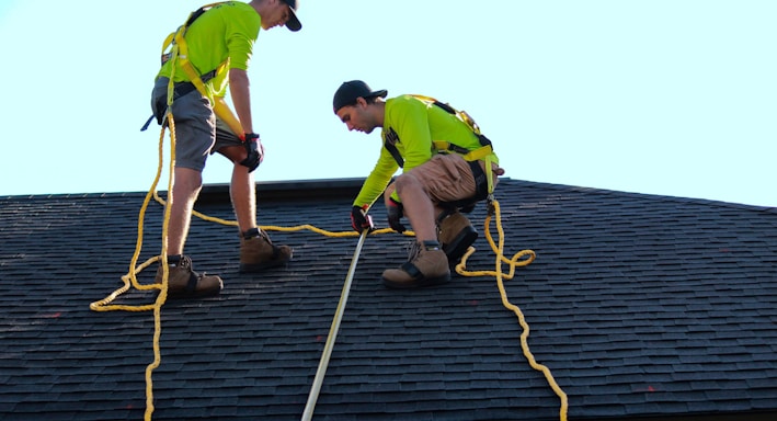 a couple of people that are on a roof