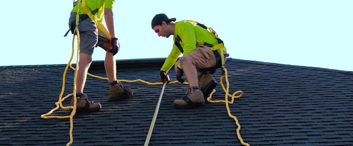 a couple of people that are on a roof