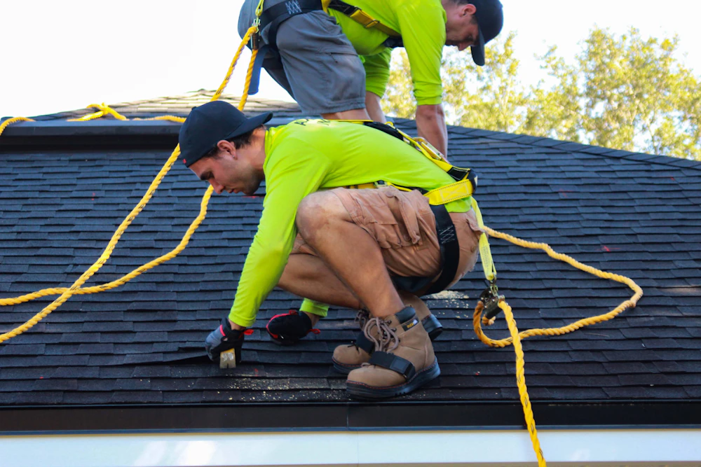 Roofing team working on a steep residential roof
