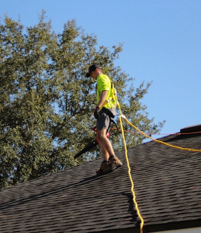a man on a roof working with a rope