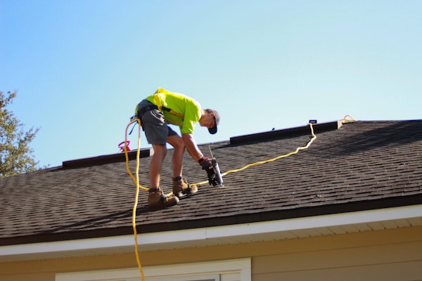 Roofer working on residential roof installation