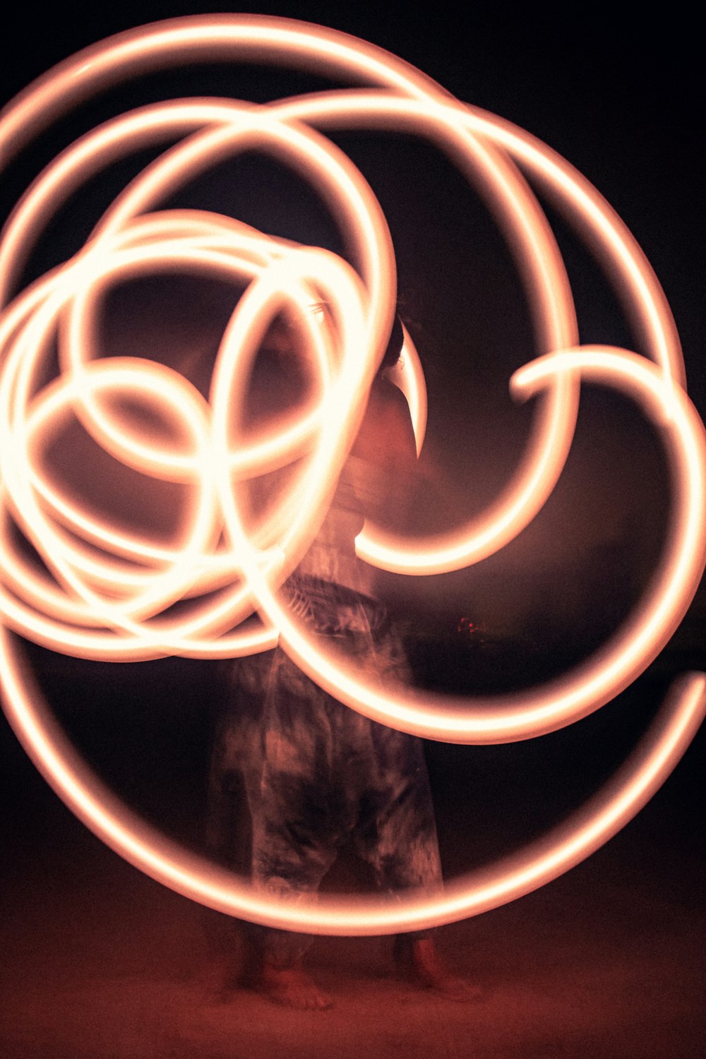 a man is spinning a circular object with his hands