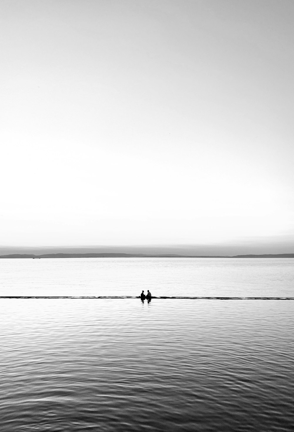 a couple of people riding on the back of a boat