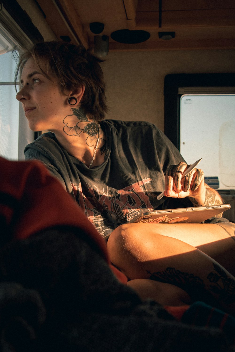 a man with tattoos sitting in a vehicle