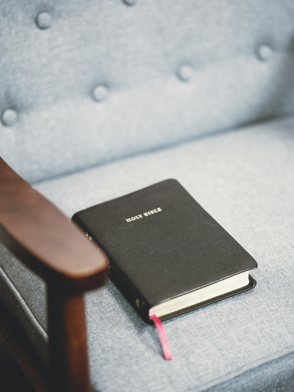 a black book sitting on top of a blue chair