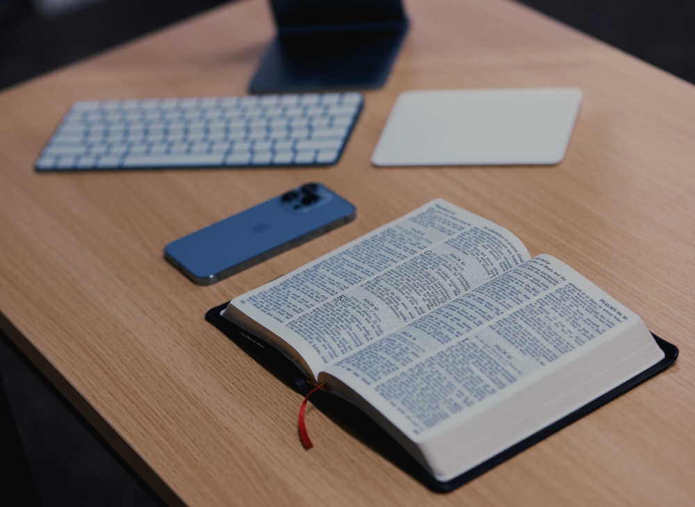 an open book sitting on top of a wooden desk